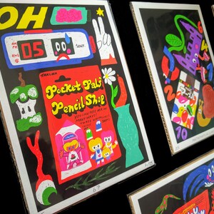 May include: A black and red illustration of a pencil shop with the text "Pocket Pals Pencil Shop" and the words "You can pose her in many ways! Three wriggly bits!"  The illustration features a green apple, a vase with a daisy, and a girl with a pink dress.