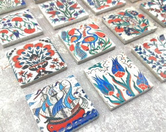May include: A set of 12 square ceramic tiles with intricate floral and geometric designs in blue, red, and green colors. The tiles are painted with a white background and have a glossy finish.