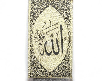 May include: A silver metal wall hanging with an ornate design. The center of the hanging features a gold fabric panel with the word "Allah" written in Arabic calligraphy.