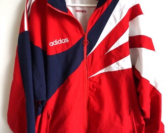 Jaqueta corta-vento vintage Adidas, estilo paraquedas, tamanhos G, GG e XGG, azul e vermelha.