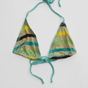 May include: A turquoise and beige striped bikini top with adjustable straps. The top has a triangle shape and ties at the neck and back.
