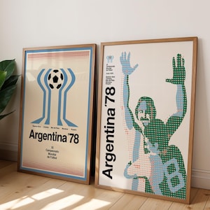 May include: Two framed posters featuring Argentina '78 World Cup soccer graphics. The left poster displays a stylized soccer ball and trophy icon. The right poster shows a halftone dot illustration of a player with arms raised, labeled Argentina '78.