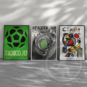 May include: Three framed posters featuring soccer tournament art. The left poster is green with a black soccer ball and text reading MEXICO 70. The center poster is black and white with ITALIA 90 text. The right poster features ESPA&Ntilde;A 82 text.