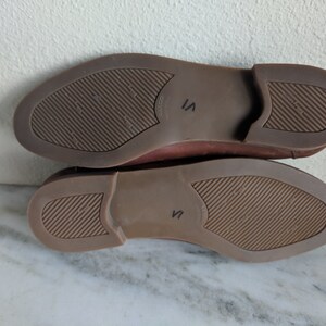 May include: The bottom of a pair of brown leather shoes with a size 7 marked on the sole.