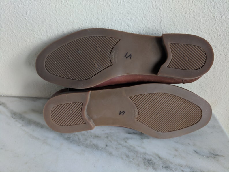 May include: The bottom of a pair of brown leather shoes with a size 7 marked on the sole.