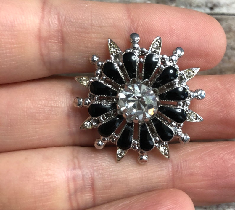 Coro vintage silver tone metal flower pin with black and clear crystals