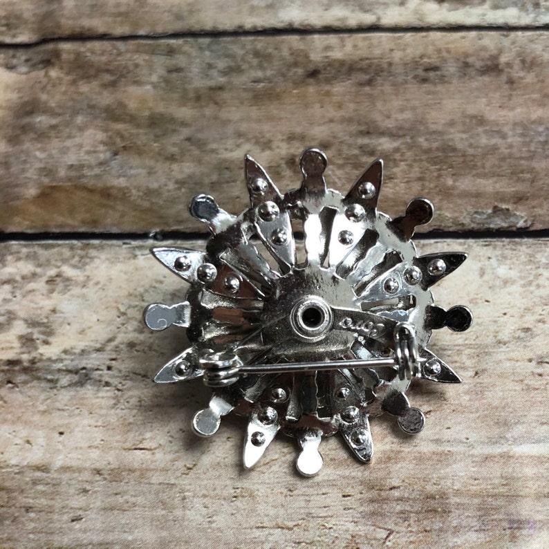 Coro vintage silver tone metal flower pin with black and clear crystals