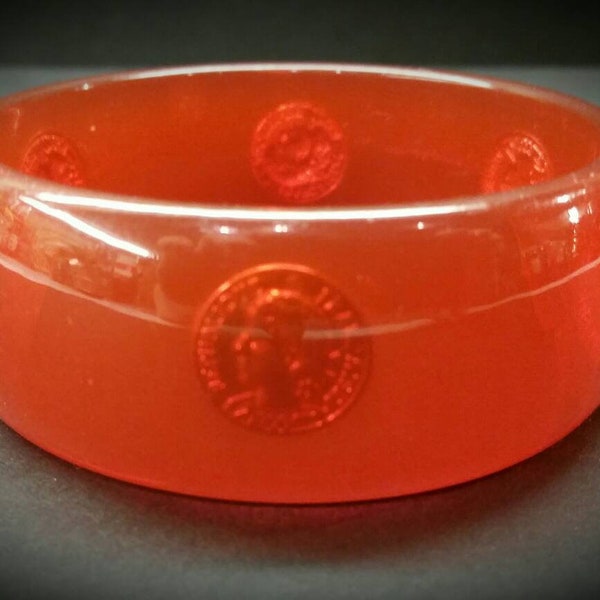 LUCITE BANGLE BRACELET Transparent Orange With Pink Hue And Embedded Faux French Coins Vintage 1970s 1980s