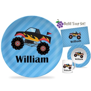 May include: A blue and white striped plate with a black monster truck with flames and the name "William" printed on it.  The plate is part of a personalized children's dinnerware set.