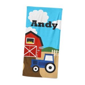 May include: A blue and red beach towel with a red barn, a blue tractor, and the name "Andy" printed on it.