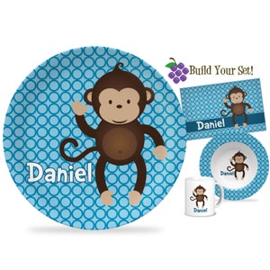 May include: A blue and brown monkey themed children's dinnerware set with the name "Daniel" on each piece. The set includes a plate, bowl, and mug.