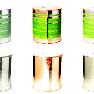 May include: Six spools of ribbon, three with a green and silver striped pattern and three with a solid silver, gold, and white metallic finish.