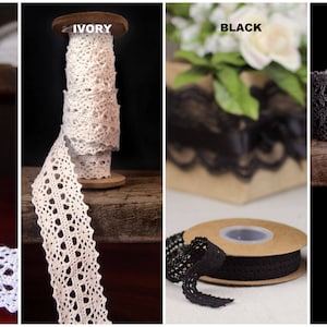 May include: Four spools of lace trim in white, ivory, black, and gray. Each spool is wrapped with lace trim and labeled with the color.