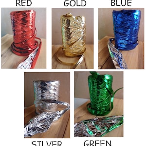 May include: Assortment of metallic curling ribbon in red, gold, blue, silver, and green. Each spool is wrapped in a metallic foil.