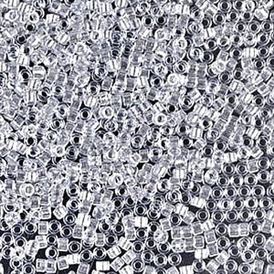 May include: Close-up of a pile of small, clear glass seed beads. The beads are cylindrical with a hole running through the center. The beads are scattered and appear to be reflective, creating a sparkling effect.