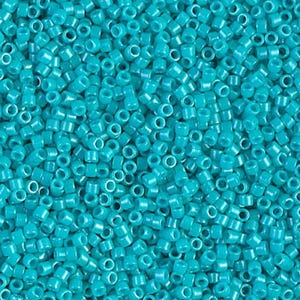 May include: A close-up shot of a pile of turquoise seed beads. The beads are small, cylindrical, and have a hole running through the center. The beads are scattered, creating a textured surface. Ideal for jewelry making and crafts.