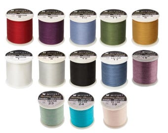 May include: Assortment of 12 spools of Miyuki Beading Thread in various colors, including red, purple, blue, green, gold, white, black, grey, pink, and turquoise. Each spool is labeled with the thread number and color code.