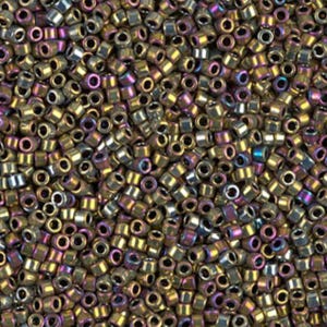 May include: A close-up view of a pile of small, cylindrical beads. The beads have a metallic finish with a mix of gold, bronze, and iridescent purple and blue hues. The beads are densely packed together.