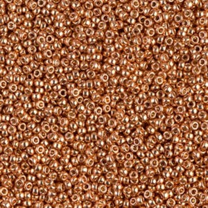 May include: Close-up of a pile of small, round, copper-colored beads. The beads are densely packed together, creating a textured surface. The beads have a metallic sheen, reflecting light and adding depth to the image. Ideal for jewelry making and crafts.