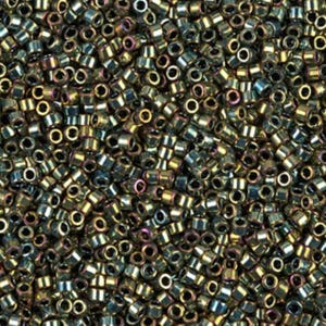 May include: A close-up shot of a pile of small, cylindrical beads. The beads have a metallic sheen with colors ranging from gold to dark green and hints of purple. They are densely packed together, filling the frame.