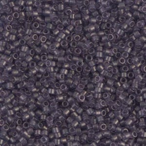 May include: A close-up view of a pile of small, cylindrical beads in a muted purple hue. The beads are densely packed together, creating a textured surface. The beads appear to be made of glass or a similar translucent material.
