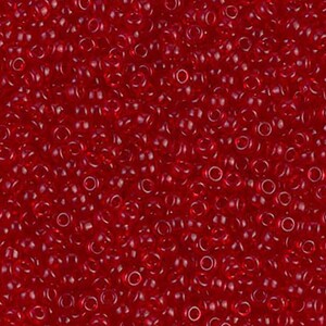 May include: A close-up view of a large quantity of small, round, red seed beads. The beads are translucent and have a slight sheen.