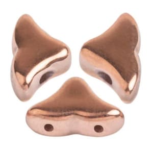 May include: Three rose gold-colored, wing-shaped beads. Each bead has a smooth, reflective surface with a curved design and two holes for stringing. The beads are arranged against a white background.