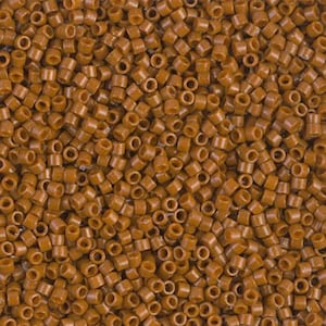 May include: A close-up view of a pile of small, cylindrical brown beads. Each bead has a hole running through the center. The beads are evenly distributed, creating a textured surface. These beads are suitable for jewelry making and crafts.
