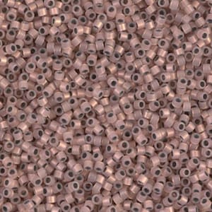 May include: A close-up view of a pile of small, cylindrical beads. The beads are a muted rose gold color with a metallic sheen. Each bead has a small hole running through the center. The beads are scattered, creating a textured surface.