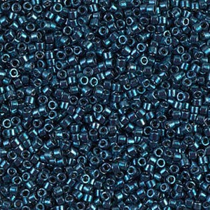 May include: Close-up of a pile of small, cylindrical, dark teal seed beads. The beads are densely packed, creating a textured surface. The beads have a metallic sheen, reflecting light. Ideal for jewelry making and crafts.