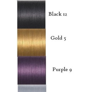 May include: Five spools of thread in different colors: white, black, gold, purple, and silver. Each spool has a number next to its color: 1, 12, 5, 9, and 3.