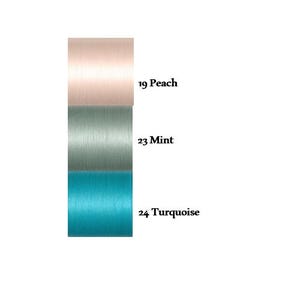 May include: A vertical display of three fabric swatches. The top swatch is peach, the middle swatch is mint, and the bottom swatch is turquoise. The swatches are labeled with numbers and names: 19 Peach, 23 Mint, and 24 Turquoise.