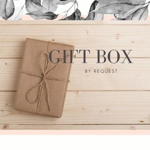 May include: A brown gift box tied with twine on a wooden background. The text "GIFT BOX BY REQUEST" is printed on the background.