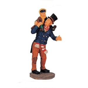 May include: A figurine of a man wearing a blue jacket, brown pants, and a top hat, carrying a child on his shoulders. The man is wearing a red and white scarf and the child is wearing a yellow jacket.