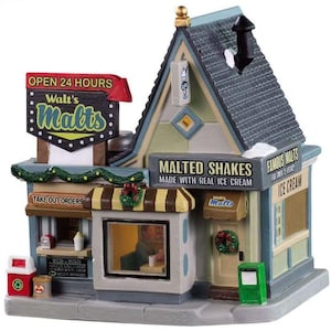 May include: A miniature model of a retro-style malt shop with a green awning, red and white sign that reads "Walt's Malts", and a sign that says "Open 24 Hours". The shop has a window with a figure inside, a take-out order window, and a door with a wreath. The building is decorated with Christmas greenery.