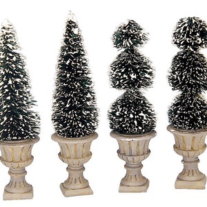 May include: Set of four miniature artificial Christmas trees in decorative pots. Two trees are single-tiered and two are double-tiered. The trees are green with white flocking and the pots are beige.