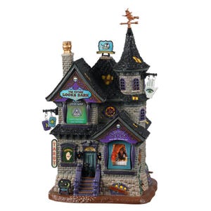 May include: A detailed, multi-level Halloween-themed decorative house with a dark color scheme. The house features signs that read "The Future Looks Dark" and "Serena". The house has a witch on top and a hand with an eye symbol.