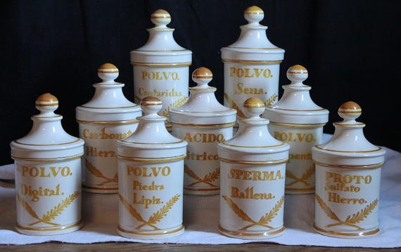 A set of three actual French vintage apothecary jars with white glaze — the kind of shelf piece that makes any room look like a 19th-century Parisian pharmacie.