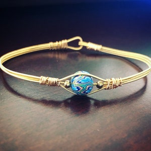 Blue beaded guitar string bracelet