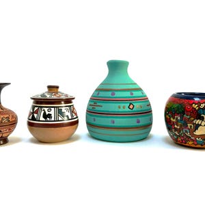 May include: Four hand-painted ceramic vessels. Includes a brown and tan vase with a dark brown neck, a lidded jar with geometric designs, a turquoise vase with horizontal stripes, and a colorful bowl with a village scene.