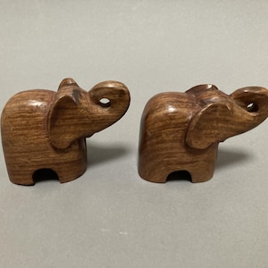 pair of hand carved elephant figurines, mid century modern design