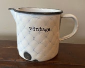 Antique enamelware chicken wire milk pitcher. Very shabby and chippy. Permanently hand lettered for interest.