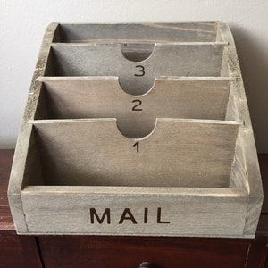 Mail holder, small desktop variety.  Rustic wood with letters and numbered slots.  Organize your mail and bills.