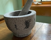 Mortar and pestle, unpolished granite. Large and sturdy. Beautiful for your counter with hand stamped botanical images.