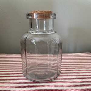 Antique food jar SCA- starting to turn light purple.  Incredible clear glass with age bubbles. Nice and unusual.