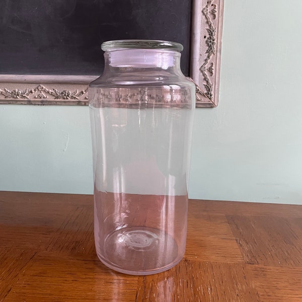 Antique tall apothecary jar starting to turn purple.  Antique pharmacy / laboratory.  Lid not original.  Rough pontil at base.  Blown glass.
