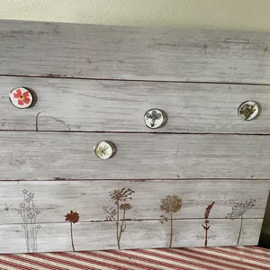 Magnetic memo board, decorative with wildflowers on the bottom.  Wall mountable.  Includes handmade pressed flower magnets.