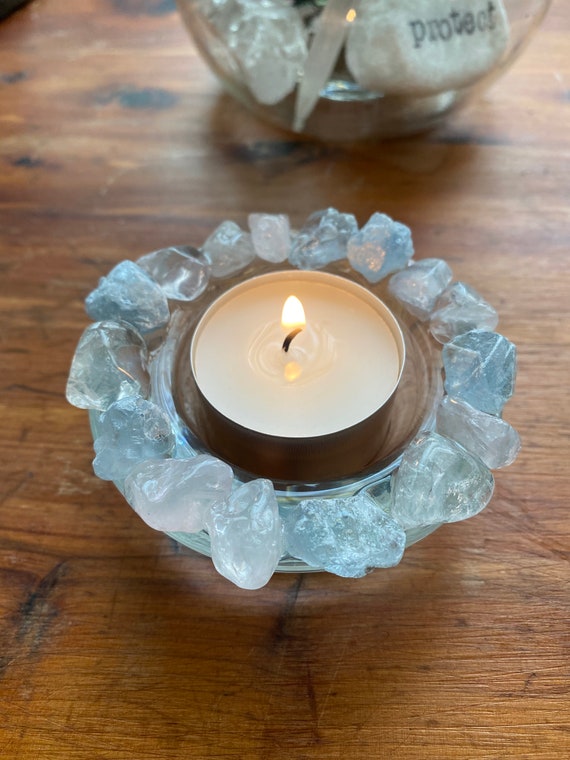 Crystal tea candle. Rough pale blue celestite surround the heavy glass cup to set off a candle flame beautifully. Natural decor