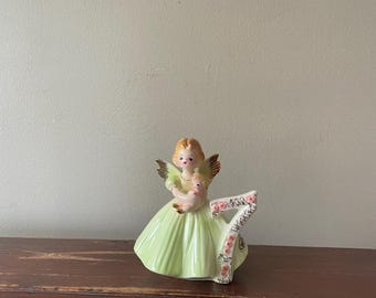 Vintage Josef Original 7th birthday angel collectible figurine.  Has  wings and she holds a baby .  Perfect grand daughter gift.