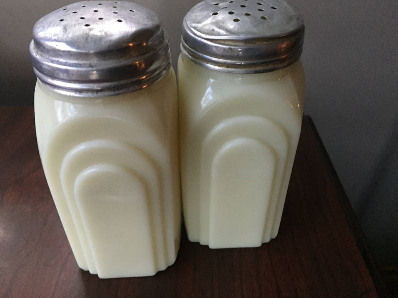 Not a reproduction set Antique salt and pepper shakers Roman Arch 1930 Mckee custard glass Range top set in good condition.